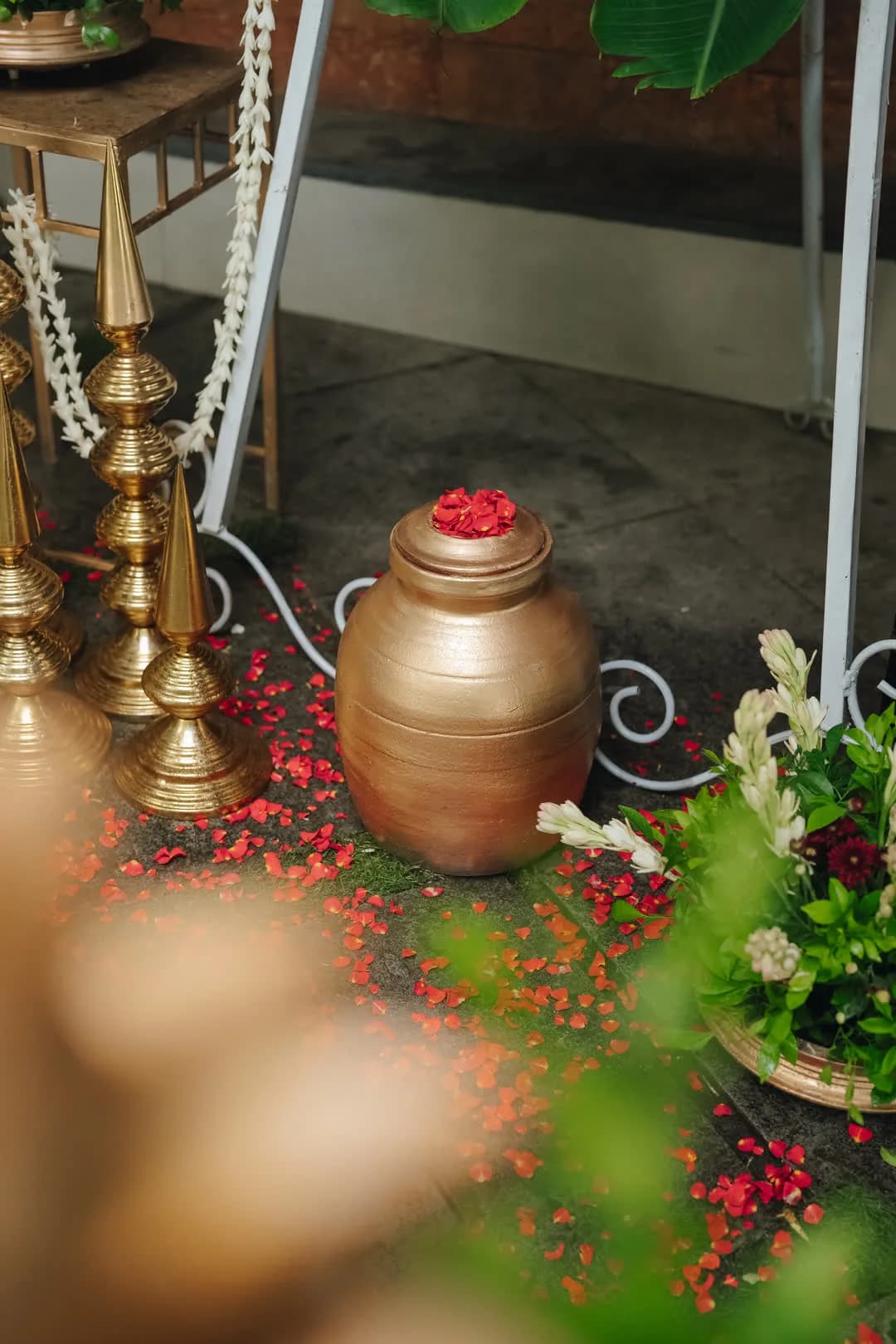 Gilded pot and scattered rose petals in the entrance decor